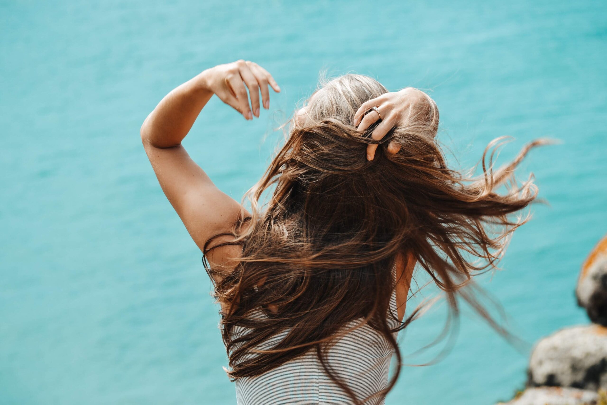 woman flipping hair in wind